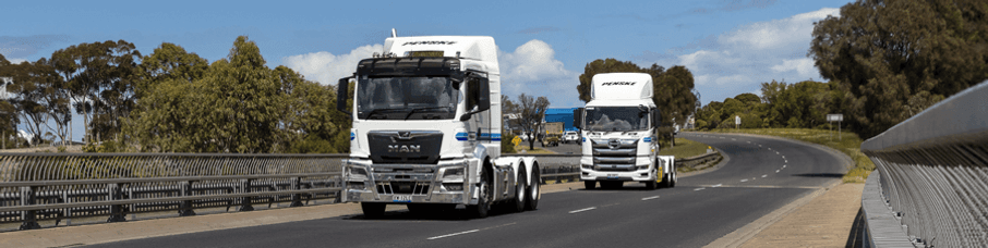 Two Penske Trucks on the road