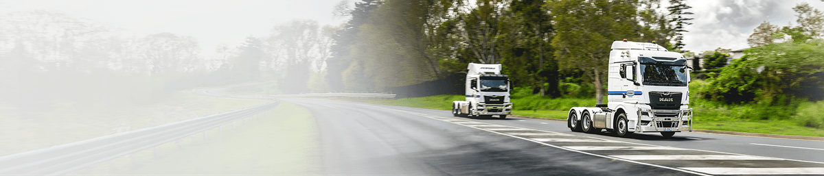 Two Penske Trucks on the road